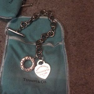 Return to Tiffany and Co. togo charm bracelet.